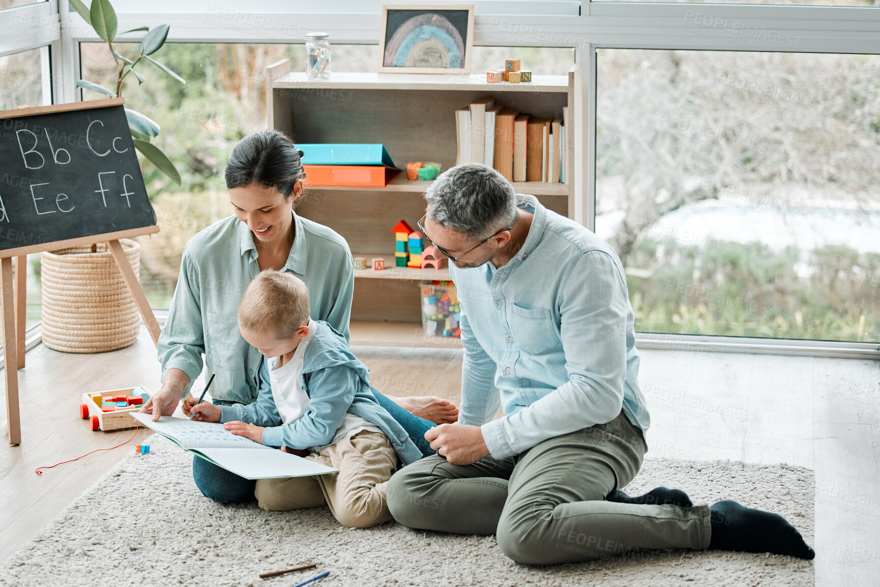 Buy stock photo Family, child and writing in book on floor with math activity, education and bonding for learning addition of study. Parents boy and numbers solution for assessment, homework and development at house