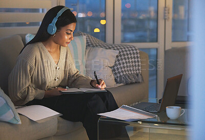 Buy stock photo Laptop, notes and woman on sofa with headphones, studying and virtual university project at night. Elearning education, research and college student with computer, webinar and online course at home