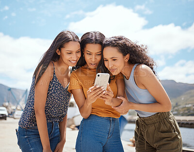 Buy stock photo Phone, happy and girl friends on holiday at harbor reading blog with gossip, celebrity headlines or news. Smile, travel and women with cellphone for online social networking together on vacation.