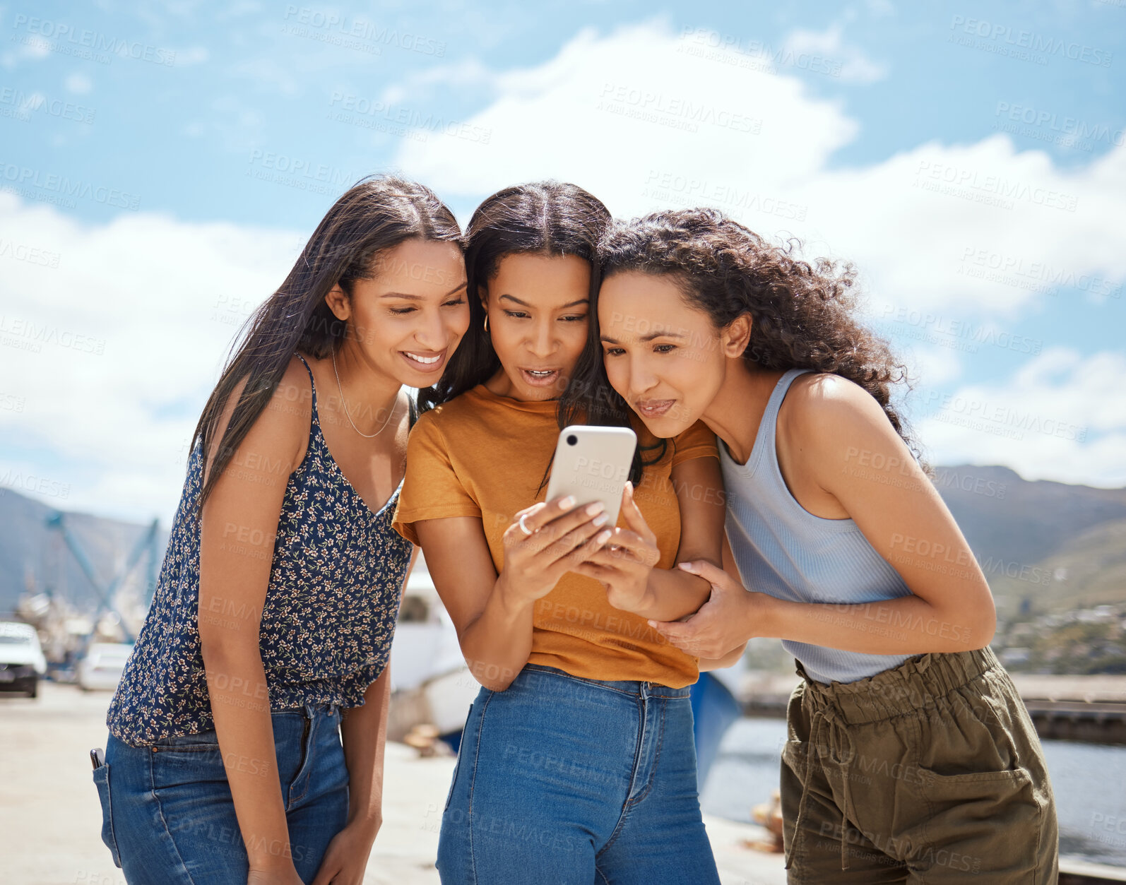 Buy stock photo Phone, happy and girl friends on holiday at harbor reading blog with gossip, celebrity headlines or news. Smile, travel and women with cellphone for online social networking together on vacation.