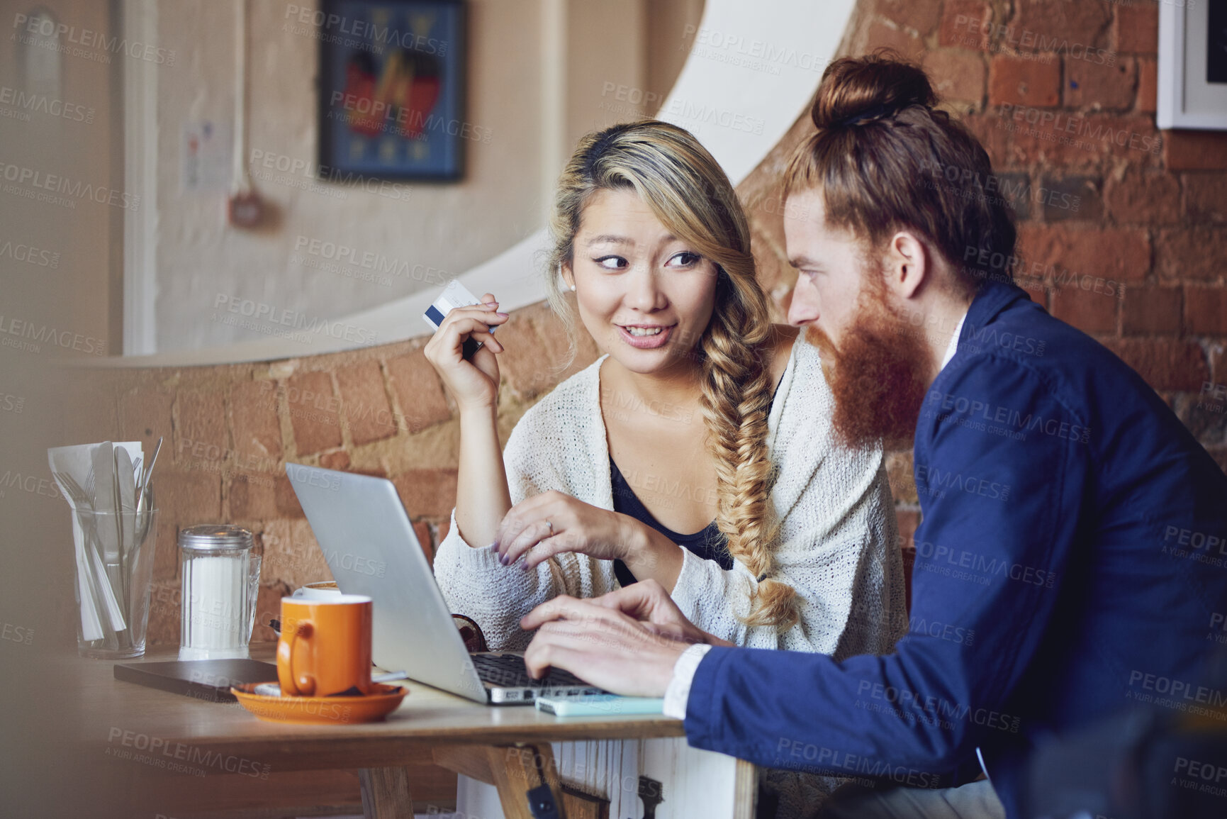 Buy stock photo Laptop, credit card and couple in cafe together with budget planning, decision or search for discount sale. Man, woman and discussion in coffee shop for online shopping, banking or account management