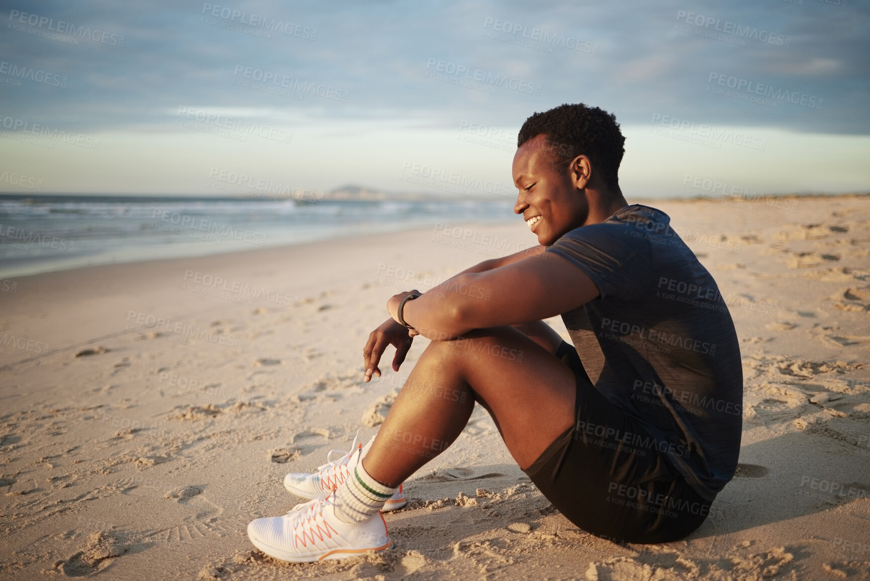 Buy stock photo Fitness, black man and break by beach at sunset for outdoor sports exercise, wellness pr rest on sand. Male person, athlete and happy with smile by ocean water for summer workout, evening or training