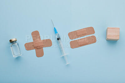 Buy stock photo Above, medical and needle for healthcare, studio and vial with vaccine, plaster and treatment in space. Top view, injection and medicine for prevention of mpox, pharmaceutical and blue background