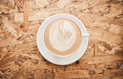 Buy stock photo Cafe, above and foam with coffee on table, hot beverage and hospitality for customer service in bistro. Top view, espresso and cappuccino with leaf pattern for creativity, breakfast and latte drink