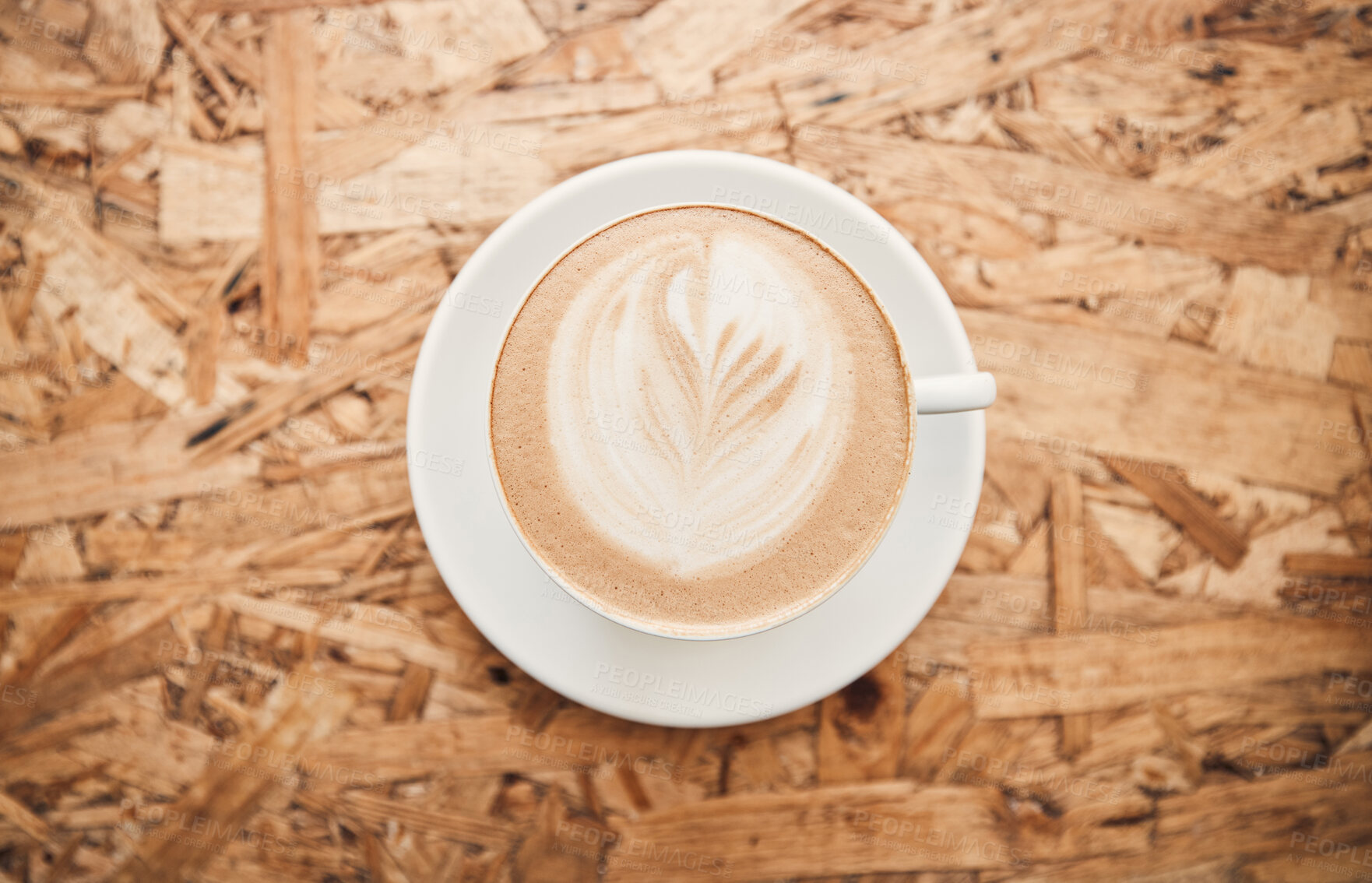 Buy stock photo Cafe, above and foam with coffee on table, hot beverage and hospitality for customer service in bistro. Top view, espresso and cappuccino with leaf pattern for creativity, breakfast and latte drink