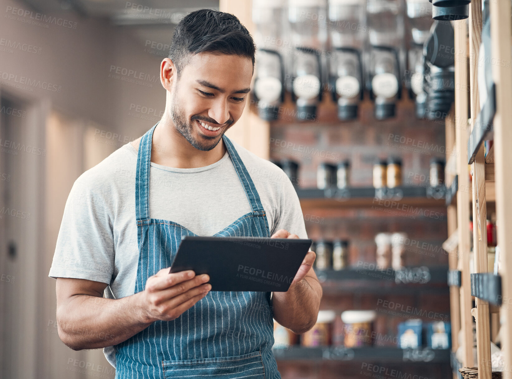 Buy stock photo Small business, asian man and smile in cafe with tablet, product check and scroll for inventory management. Coffee shop, manager and barista with digital for stock quality, startup or online services