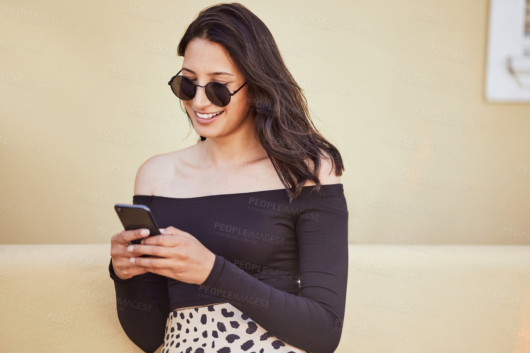 Buy stock photo Woman, sunglasses and travel with phone in city for outdoor adventure, communication and holiday update. Smile, happy and female person with technology by buildings for social media, post or vacation