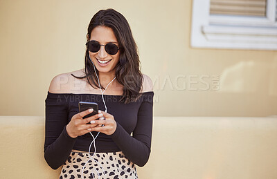 Buy stock photo Woman, earphones and journey with phone in city for outdoor travel, adventure and listening to music. Sunglasses, smile and female person with technology by building for holiday, playlist or vacation