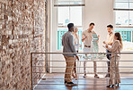 Group of diverse architects discussing plans, blueprints and schematics during a meeting in their office boardroom. Business people brainstorming and planning their upcoming project development