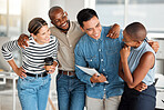 Group of diverse cheerful businesspeople spending time in an office together at work. Joyful business professionals smiling while bonding at work