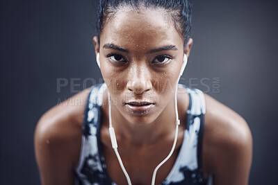 Buy stock photo Woman, portrait and music break on run, outdoor and athlete fatigue with sweat by gray background. Female person, exhausted and earphones for listening to song, tired and cardio challenge with audio