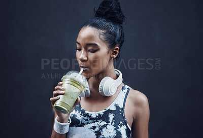 Buy stock photo Woman, headphones and green healthy smoothie for diet, nutrition and energy with kale, organic liquid and fruit. Female person, drinking and vegan juice for weight loss, natural detox or protein rich