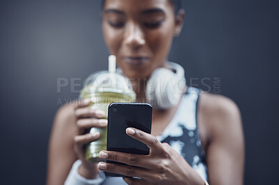 Buy stock photo Hands, fitness and phone in city with person, runner and smoothie for nutrition, detox or wellness by wall. Woman, smartphone and green juice for hydration, diet and training with break in Costa Rica