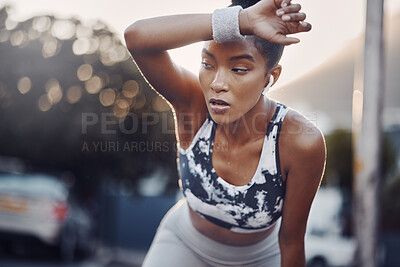 Buy stock photo Woman, runner and tired with earphones in city at sunset with sweat, breathe and burnout with music in street. Girl, break and audio streaming for workout, fitness and fatigue on road in Costa Rica