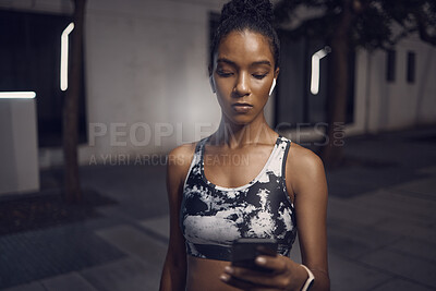 Buy stock photo Black woman, workout and gym with wireless headphones and phone break from training. Sport, music and audio on social media with mobile text and streaming fitness track for wellness and health