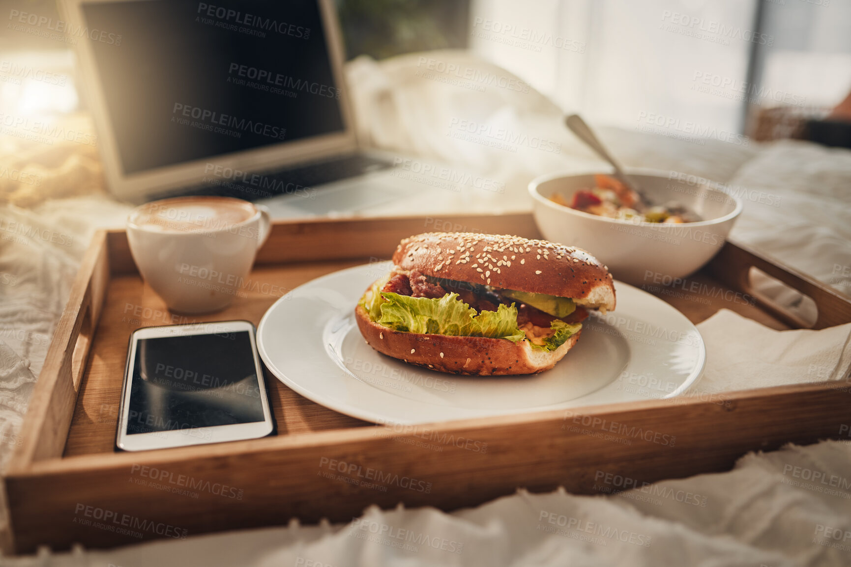 Buy stock photo Bagel, food or breakfast tray with coffee on bed for room service, meal or eating at hotel. Bread, snack and phone screen, cappuccino or muesli for catering or hospitality in bedroom at luxury resort