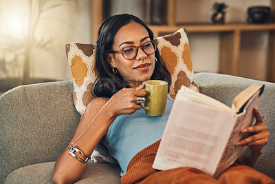 Buy stock photo Coffee, book and relax with woman on sofa in living room of home for knowledge, reading or wellness. Caffeine, literature and storytelling with person in apartment on weekend for break or recovery