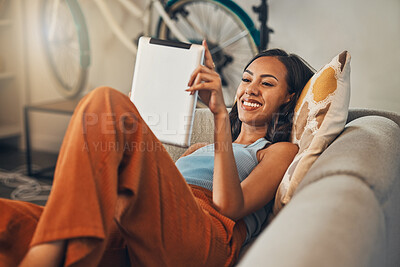 Buy stock photo Reading, smile and tablet with woman on sofa in living room of home for knowledge or wellness. Ebook, literature and storytelling with happy person in apartment on weekend for break or recovery