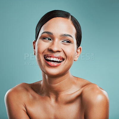 Buy stock photo Laughing, thinking or happy woman with beauty, skincare or glow in studio on blue background. Treatment ideas, smile or confident girl model with facial health for wellness, shine or makeup in France