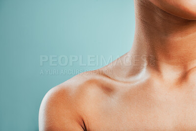 Buy stock photo Body, collarbone and dermatology with woman in studio isolated on blue background for hygiene closeup. Beauty, skincare and wellness with model person on mockup space for natural cosmetics treatment