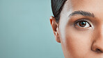 Closeup view of a mixed race woman posing against a green background. Female showing her healthy smooth soft skin in a studio