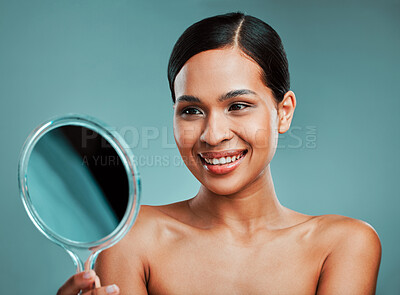 Buy stock photo Results, mirror or happy woman with beauty, makeup or skincare glow in studio on blue background. Cosmetics treatment, proud or confident girl model with facial health for smile or shine in France