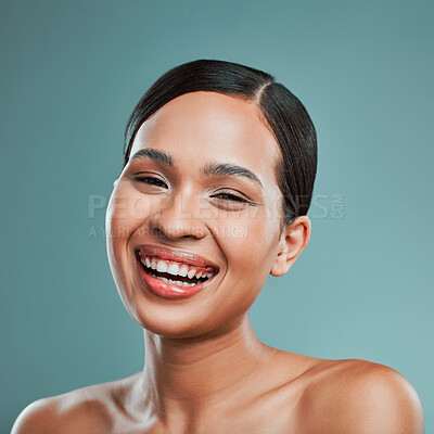 Buy stock photo Laughing, portrait or happy woman with makeup, skincare or beauty glow in studio on blue background. Cosmetics treatment, smile or confident girl with facial health for wellness or shine in France