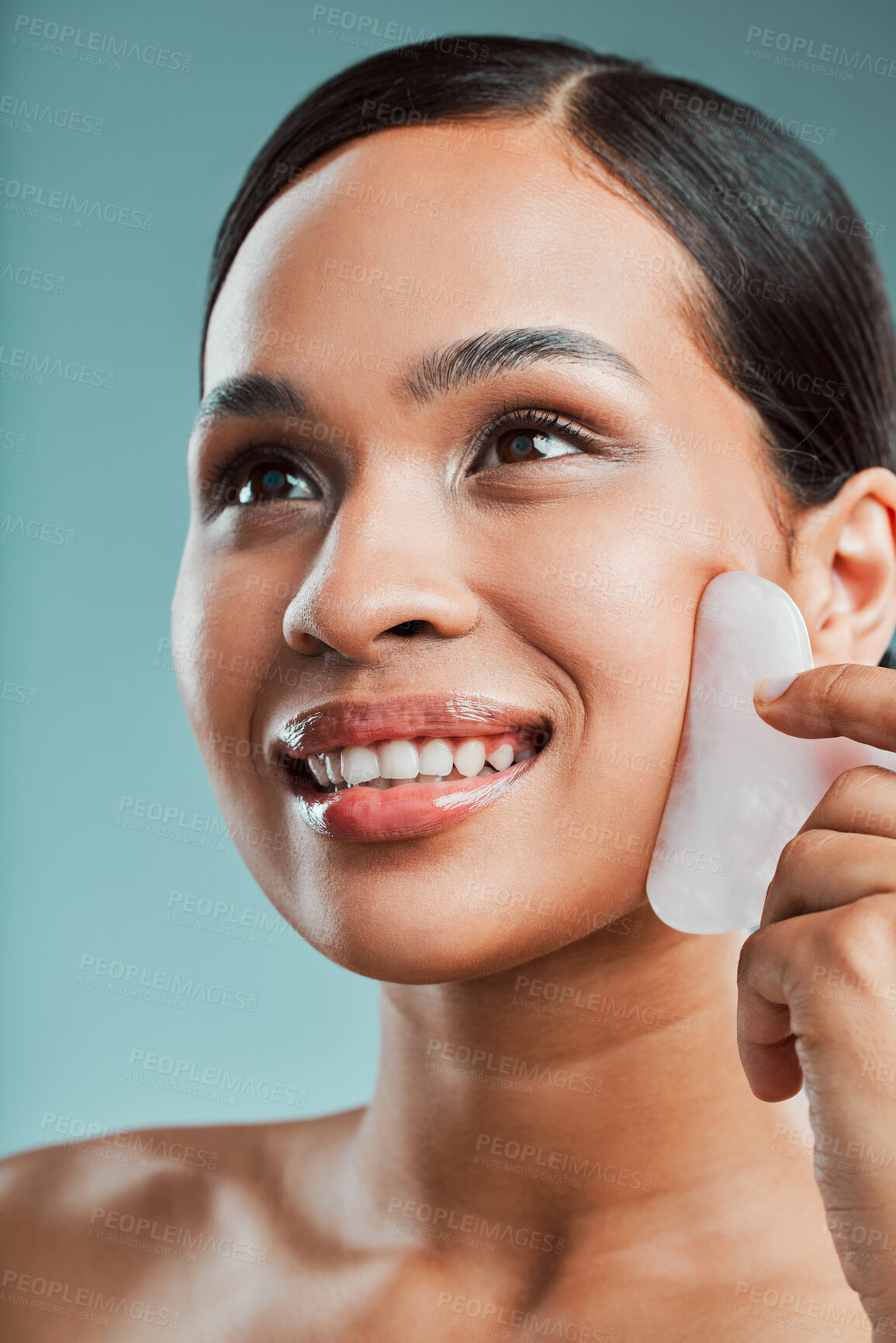 Buy stock photo Skincare, beauty or woman with gua sha for massage in studio on blue background for wellness. Healthy glow ideas, thinking or happy model with stone for facial treatment, cosmetics and facelift tools