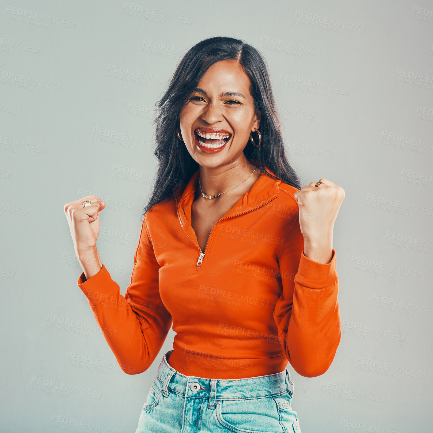 Buy stock photo Portrait, cheering and woman with celebration and excited and achievement on gray studio background. Face, person and model with prize, success and emoji with happiness, smile and winner with goals