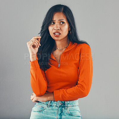 Buy stock photo Thinking, frustrated and annoyed woman in studio for opinion, review or shocked with decision. Anger, doubt and confused girl with stress, omg or drama crisis with expression on grey background