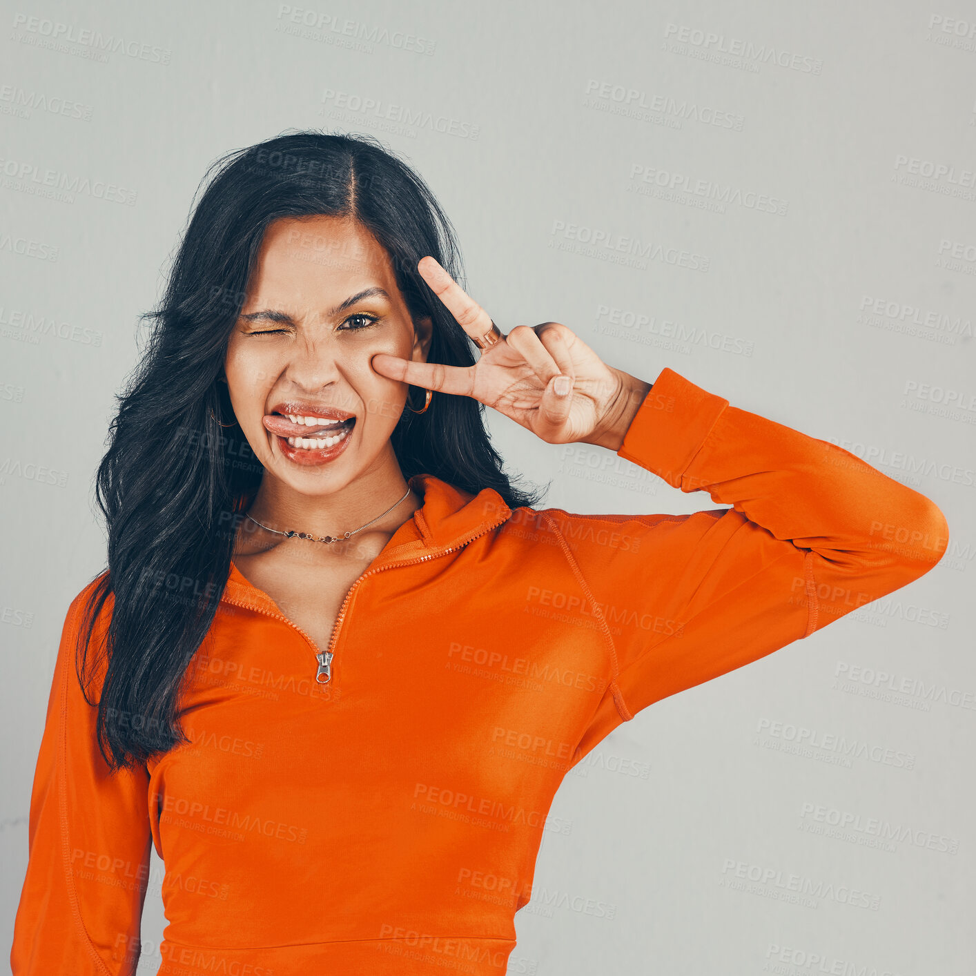 Buy stock photo Fashion, peace sign and portrait with woman in studio for winking, gen z and casual style. Trendy, college and education with person on gray background for confidence, tongue out and University pride