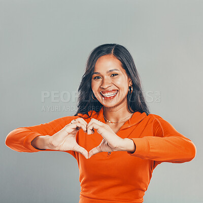 Buy stock photo Heart hands, portrait and smile of woman in studio on gray background for romance or valentines day. Emoji, social media and love with happy person showing shape for cardiovascular health or wellness