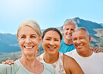 POV of a group of active seniors posing together for a selfie on a sunny day against a mountain view background. Happy retirees exercising together outdoors. Living healthy and active lifestyles