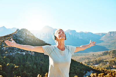 Buy stock photo Woman, headphones or freedom on mountain outdoor for fitness achievement, exercise victory or workout goals. Mature, person and happy with hands raised on hill for training success with mockup space