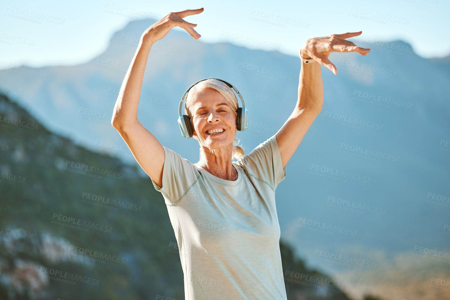 Buy stock photo Senior, happy woman or dancing with headphones on mountain for music, peace or tranquility in nature. Mature, female person or yogi with smile or headset for outdoor freedom, listening or zen podcast