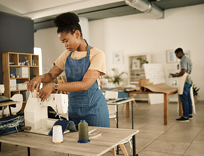 Buy stock photo Fashion designer, serious and woman with sewing machine, working and thinking of design and threading. Seamstress, creative and black person in workshop, tailoring and professional dressmaker