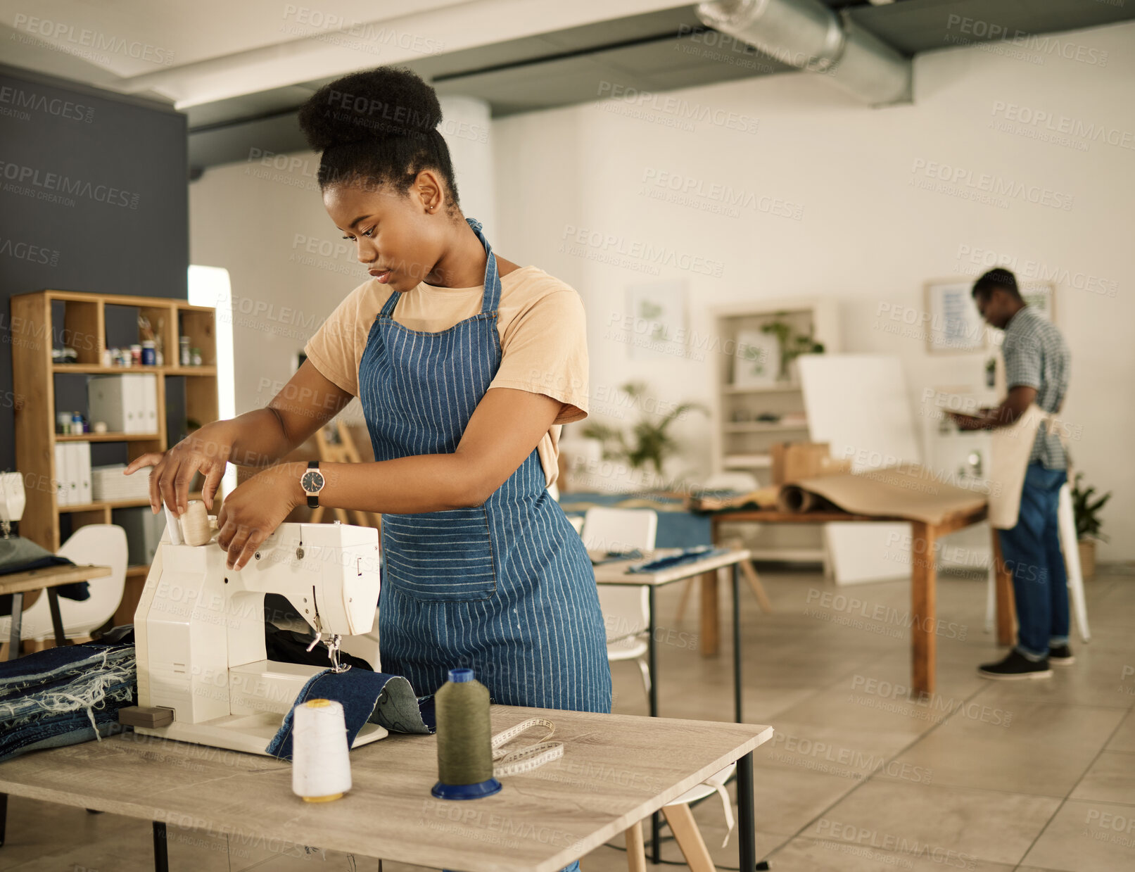 Buy stock photo Fashion designer, serious and woman with sewing machine, working and thinking of design and threading. Seamstress, creative and black person in workshop, tailoring and professional dressmaker