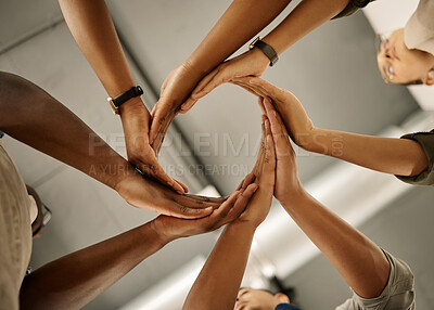 Buy stock photo Circle, below and hands of people in huddle for group mission, support and startup together. Workshop, low angle and designers with synergy for manufacturing industry, textile production or teamwork