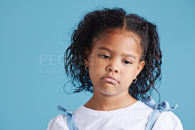 Buy stock photo Sad, girl and child with thinking in studio with depression, unhappy and moody for mental health by space. Person, kid and thoughtful face for attention, grumpy and drama on blue background.