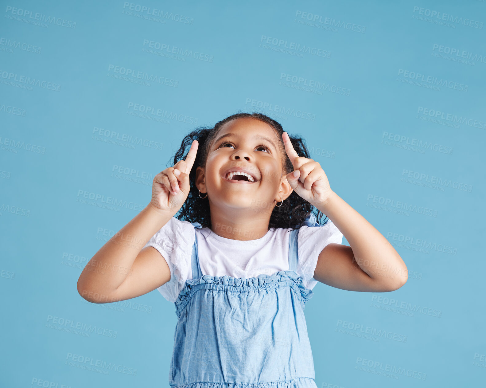 Buy stock photo Studio, child and pointing with smile for marketing, product placement and branding by mockup space. Kid, girl and showing with gesture for advertising, sale or back to school deal by blue background