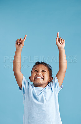 Buy stock photo Pointing, space and promotion with boy in studio for idea, announcement and information. Direction, notification and decision with child on blue background for show, presentation and process mockup