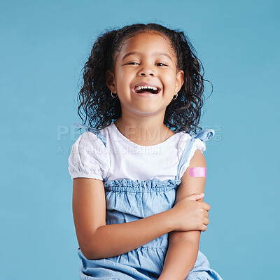 Buy stock photo Happy, plaster and portrait of child in studio for injection, vaccine or medical booster shot. Excited, healthcare and girl kid from Mexico with bandage on arm for immunization by blue background.