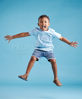 Buy stock photo Studio, child and boy with energy for jump, playful and freedom with celebration for back to school. Male person, kid and scream with game for kindergarten, childhood and flying by blue background