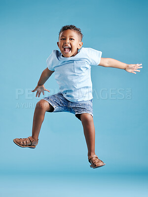 Buy stock photo Studio, kid and boy with energy for jump, playful and freedom with celebration for back to school. Male person, child and scream with game for kindergarten, childhood and flying by blue background