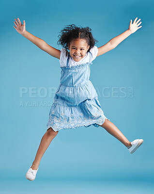 Buy stock photo Studio, child and portrait with energy for jump, playful or freedom with celebration for back to school. Female person, kid or excited with game for kindergarten, childhood or girl by blue background