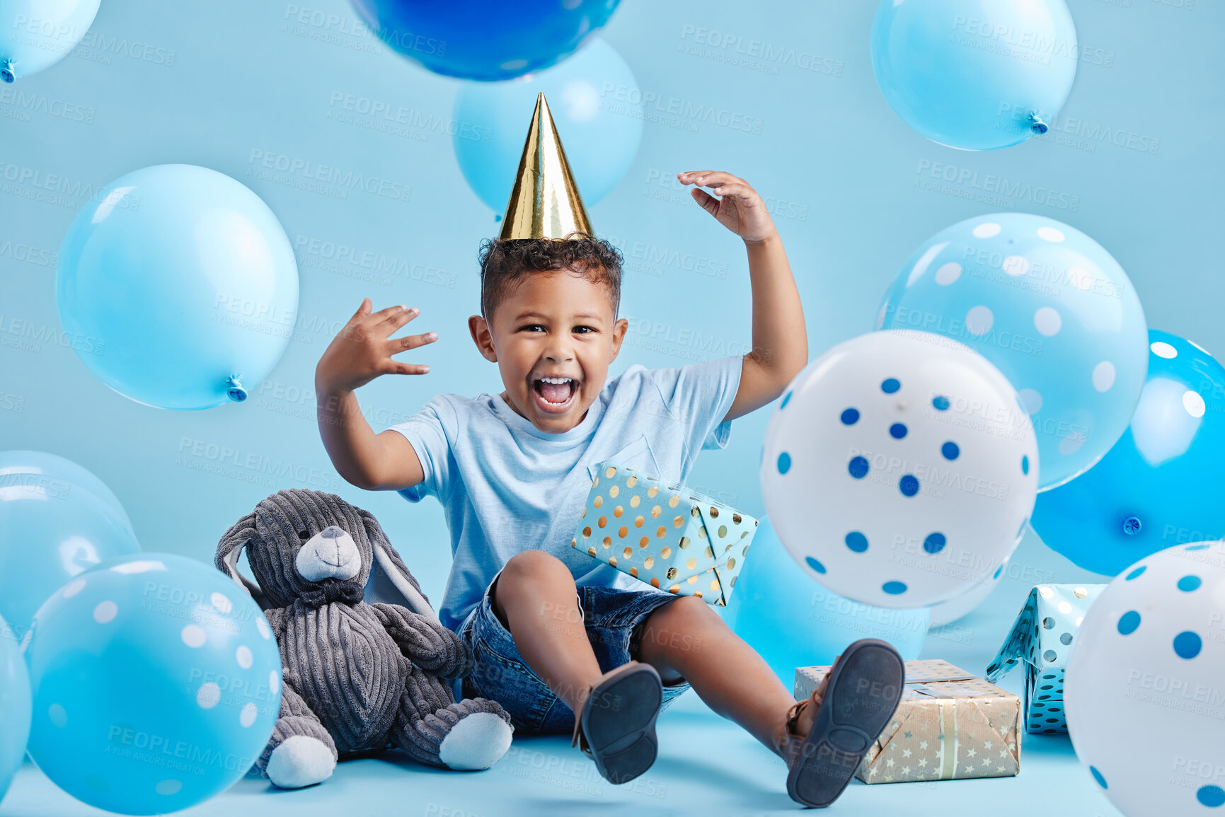 Buy stock photo Boy, child and balloons for birthday party in studio portrait with present, happy or bunny doll by blue background. Kid, boxes and gift with toys, excited or celebration for milestone in Costa Rica