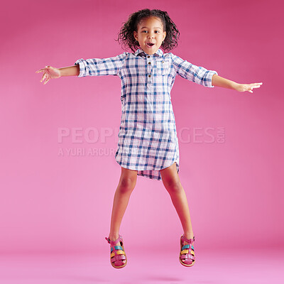 Buy stock photo Excited, jump and portrait of child on pink background with good news, celebration and happy with energy. Fashion, joy and isolated young girl in air for achievement, victory and winning in studio