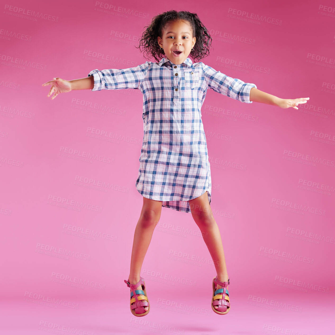 Buy stock photo Excited, jump and portrait of child on pink background with good news, celebration and happy with energy. Fashion, joy and isolated young girl in air for achievement, victory and winning in studio