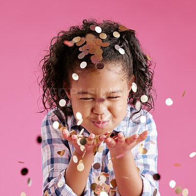 Buy stock photo Girl, child and confetti in hands, studio and excited with eyes closed for celebration by pink background. Kid, happy and glitter for cheers, smile or milestone with decor at event for birthday party