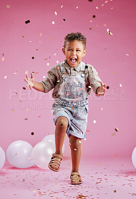 Buy stock photo Boy, child and happy with confetti in studio, excited and shout for celebration by pink background. Kid, dance and glitter for cheers, jump and balloons with smile, event or memory at birthday party